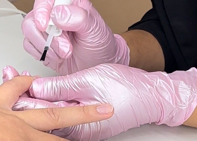 Nail technician at Koolelo X Get Nailed Academy, Zürich, Zürich, CH, applying polish with precision.