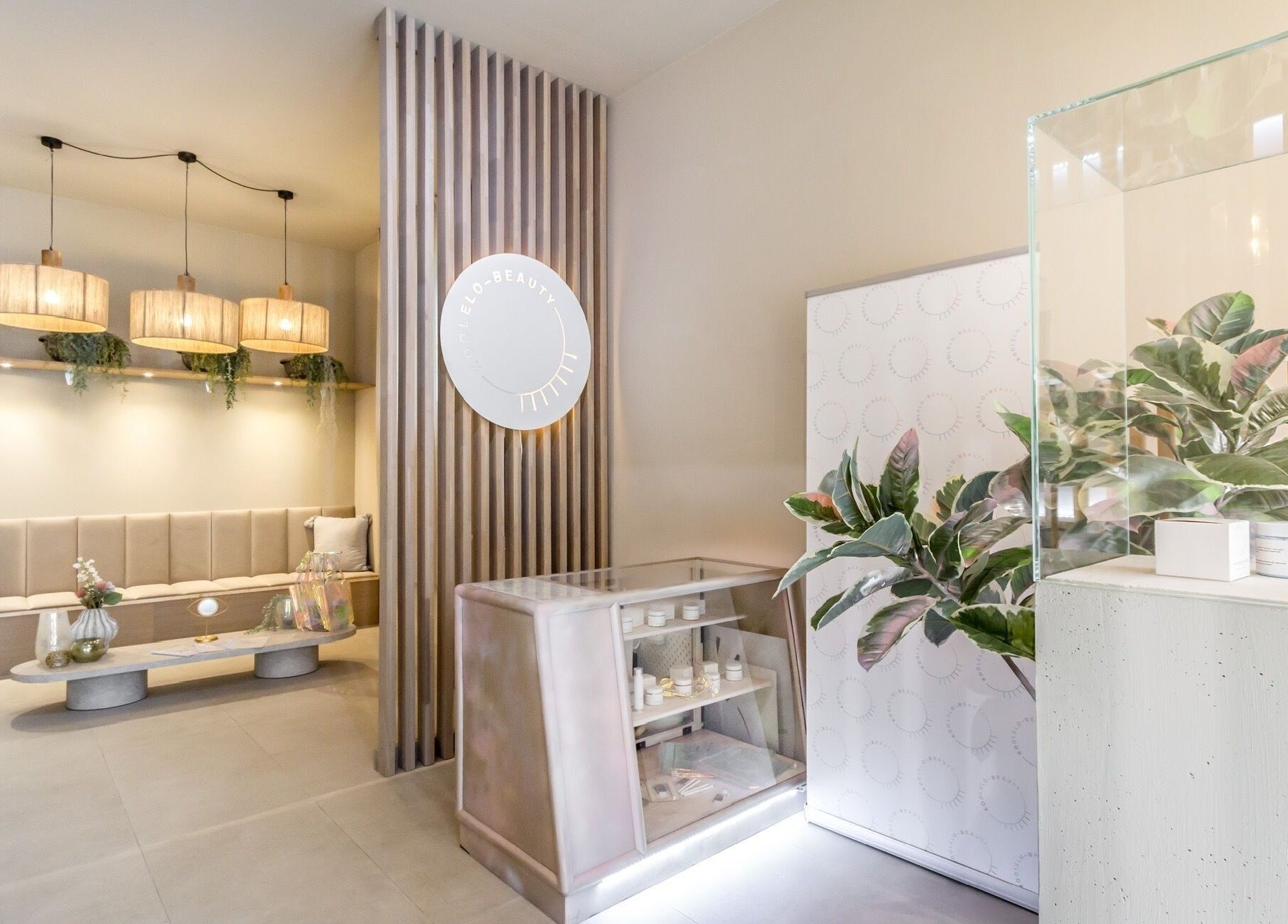 Elegant interior at Koolelo X Get Nailed Academy in Zürich, CH, showcasing modern design and lush greenery.