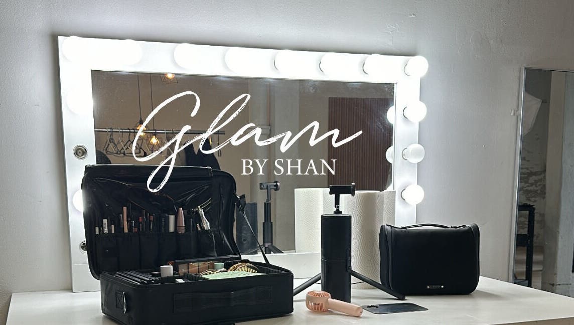 Makeup station at Glam By Shan, Newmarket, Ontario, CA, featuring a lit mirror and organized beauty tools.