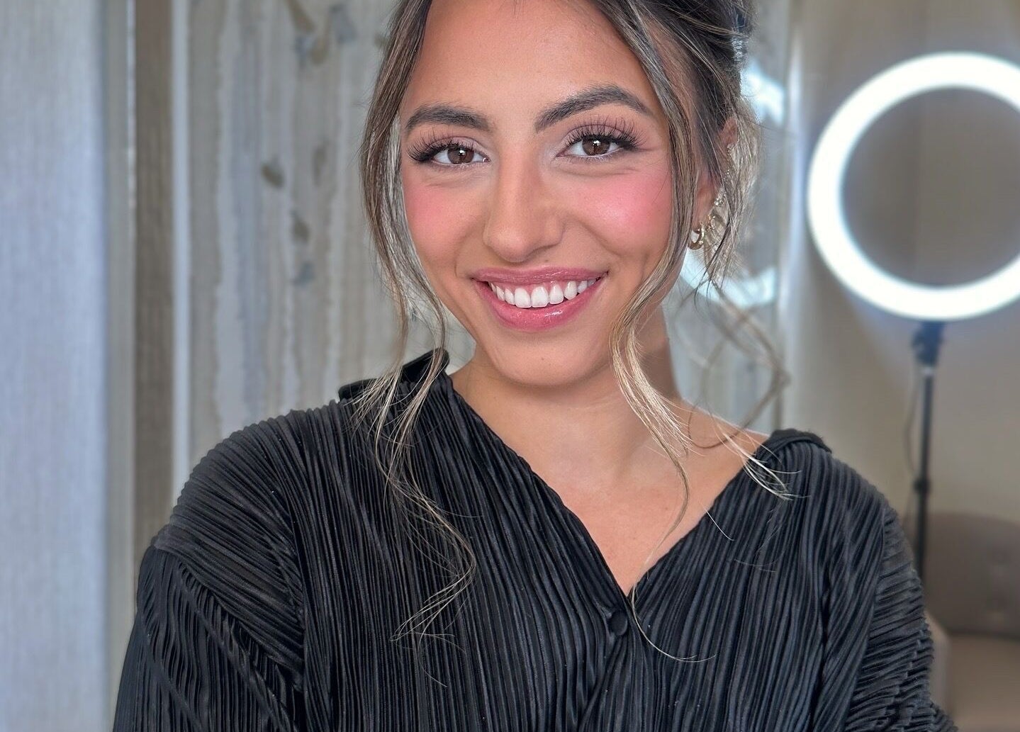 Woman with glowing makeup smiling at Glam By Shan, Newmarket, Ontario, CA.