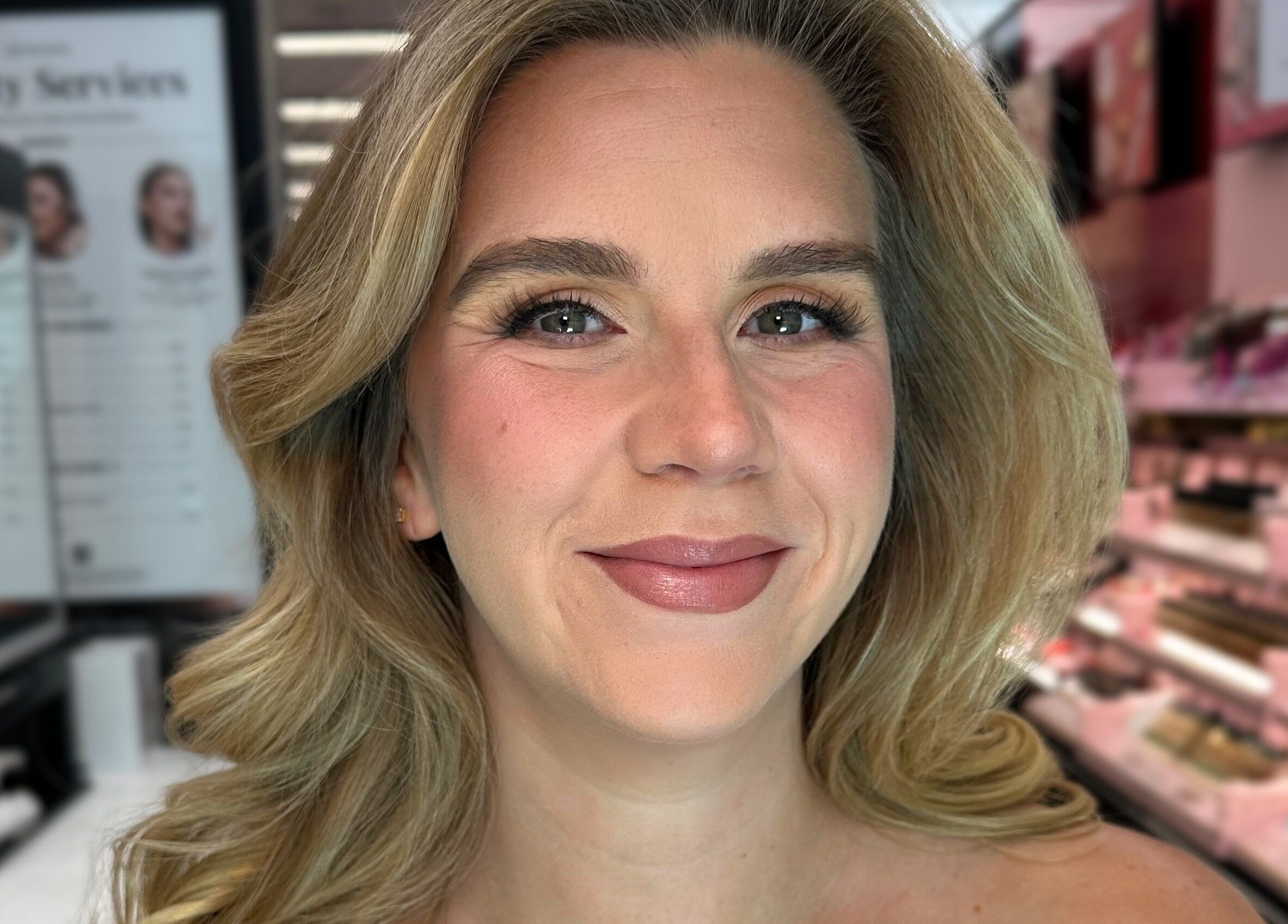 Client showcasing makeup at Glam By Shan, Newmarket, Ontario, CA, in a vibrant beauty setup.