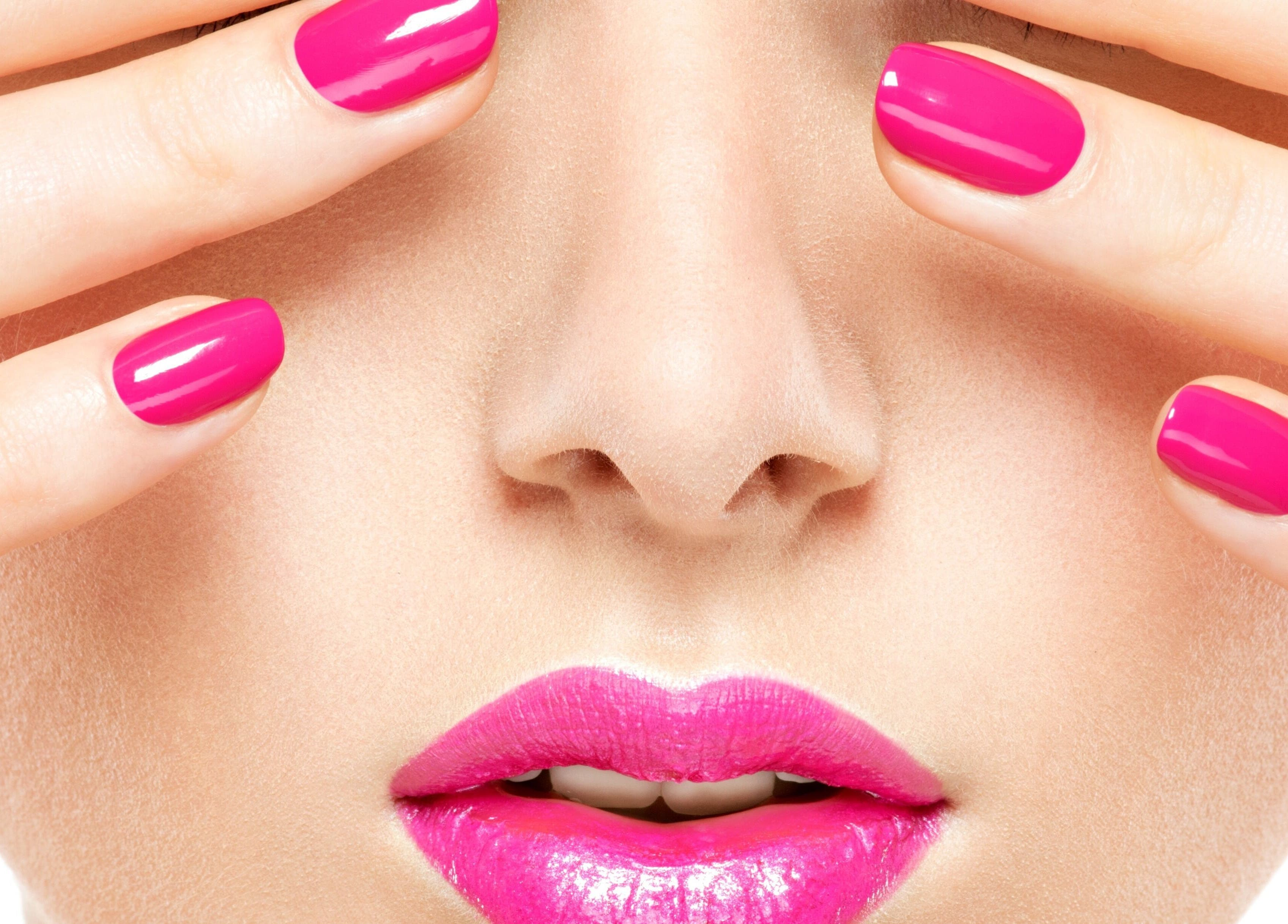 Close-up of vivid pink nails and lips. Haus of Skin, Klein Brak River, Western Cape, ZA.