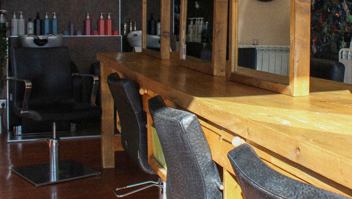 Jody Brooks at Urban Space in Saint Leonards, England, GB. Cozy salon setup with mirrors and chairs.