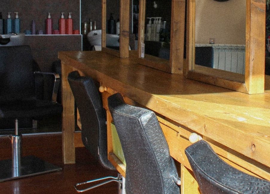 Jody Brooks at Urban Space in Saint Leonards, England, GB. Cozy salon setup with mirrors and chairs.