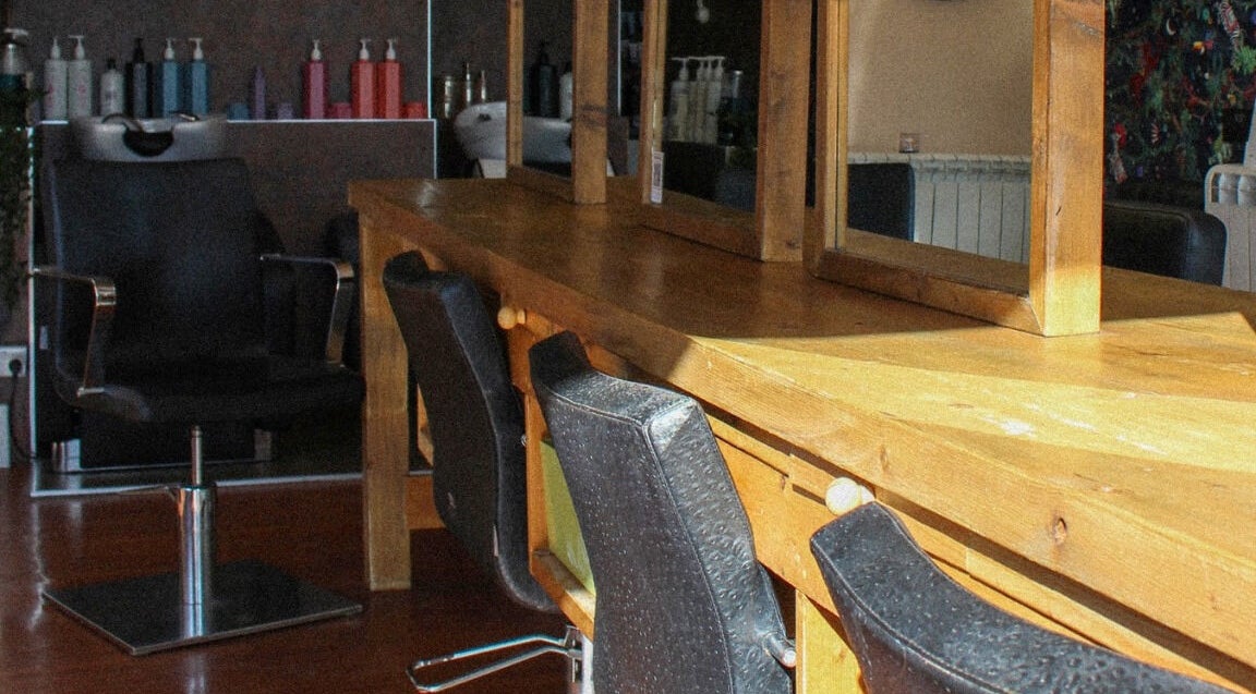 Jody Brooks at Urban Space in Saint Leonards, England, GB. Cozy salon setup with mirrors and chairs.