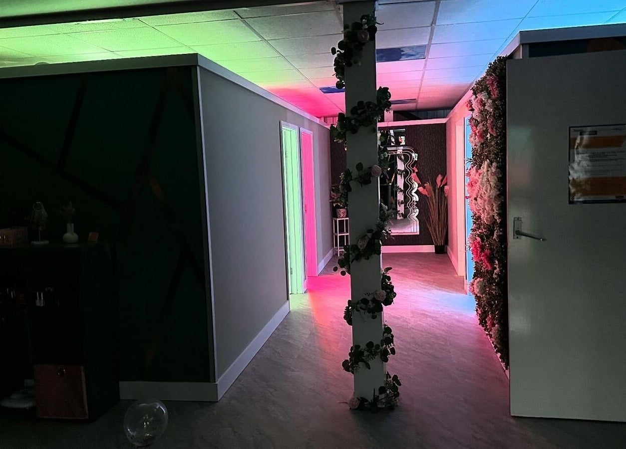 Vibrant hallway with floral decor and neon lighting at Utopia Wymondham, Wymondham, England, GB.