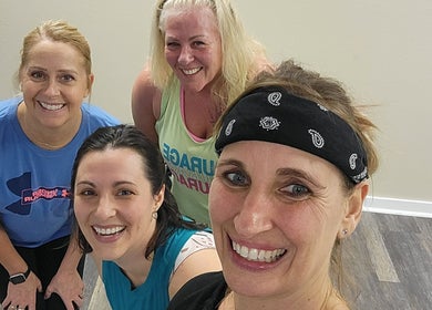 Group of women smiling during a workout at Stealth Fitness in Green Bay, Wisconsin, US.