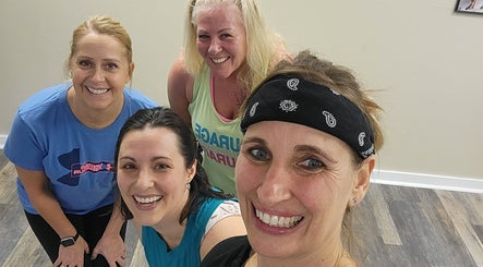 Group of women smiling during a workout at Stealth Fitness in Green Bay, Wisconsin, US.