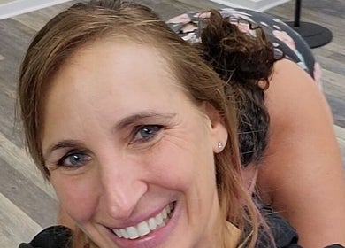 Smiling woman in workout gear at Stealth Fitness, Green Bay, Wisconsin, US.