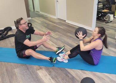 Two people engaged in partner workout at Stealth Fitness, Green Bay, Wisconsin, US.