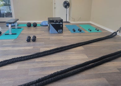Stealth Fitness in Green Bay, Wisconsin, US offers a diverse workout space with ropes, weights, and mats for fitness.