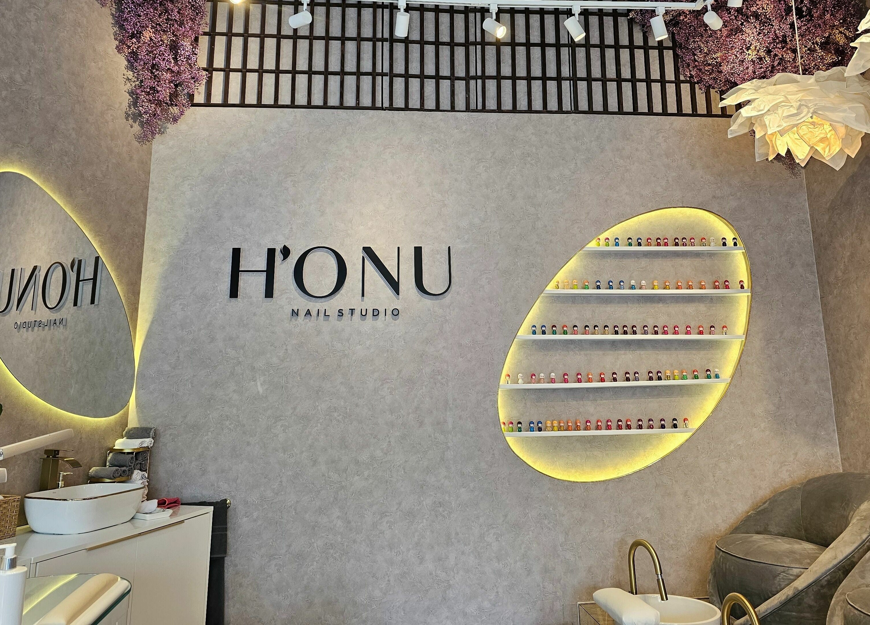 Elegant interior of Honu Nail Studio - West Hampstead, London, England, GB with sleek decor and accent lighting.