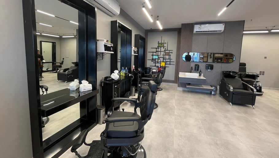 Modern interior of The Address Barber | صالون العنوان النزهة in Riyadh, with stylish chairs and mirrors.