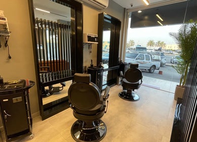 Interior of The Address Barber | صالون العنوان النزهة in Riyadh, featuring modern barber chairs and mirrors.