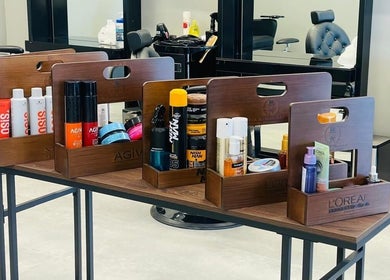 Grooming products at The Address Barber | صالون العنوان النزهة, Riyadh, Riyadh Province, SA, on a stylish table.