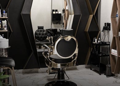 Interior of The Address Barber | صالون العنوان القيروان in Riyadh, showcasing a stylish and luxurious barber chair.