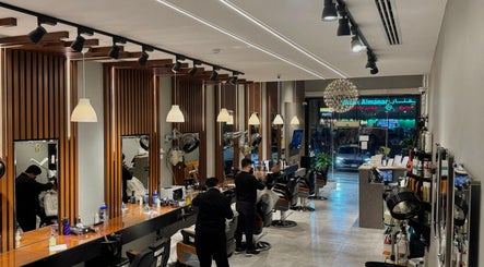 Interior of The Address Barber | صالون العنوان القيروان in Riyadh, styled mirrors and modern decor.