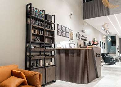 Stylish interior of The Address Barber | صالون العنوان القيروان in Riyadh, Riyadh Province, SA with products on display.
