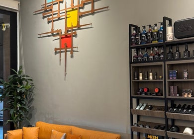 Interior of The Address Barber | صالون العنوان القيروان, Riyadh, showcasing a modern decor and product display.