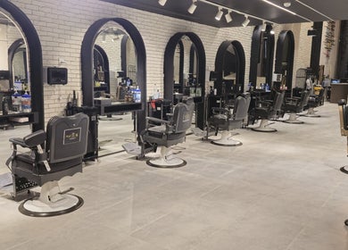 Elegant interior of The Address Barber | صالون العنوان اشبيليا in Riyadh, showcasing stylish barber chairs.