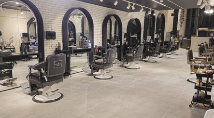 Elegant interior of The Address Barber | صالون العنوان اشبيليا in Riyadh, showcasing stylish barber chairs.