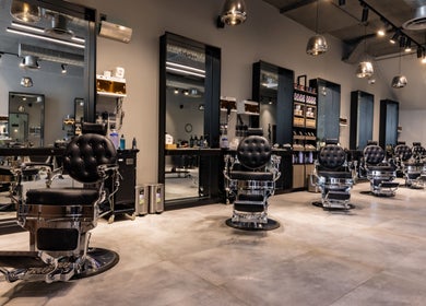 Stylish interior of The Address Barber | صالون العنوان الملقا in Riyadh, Riyadh Province, SA featuring classic barber chairs.