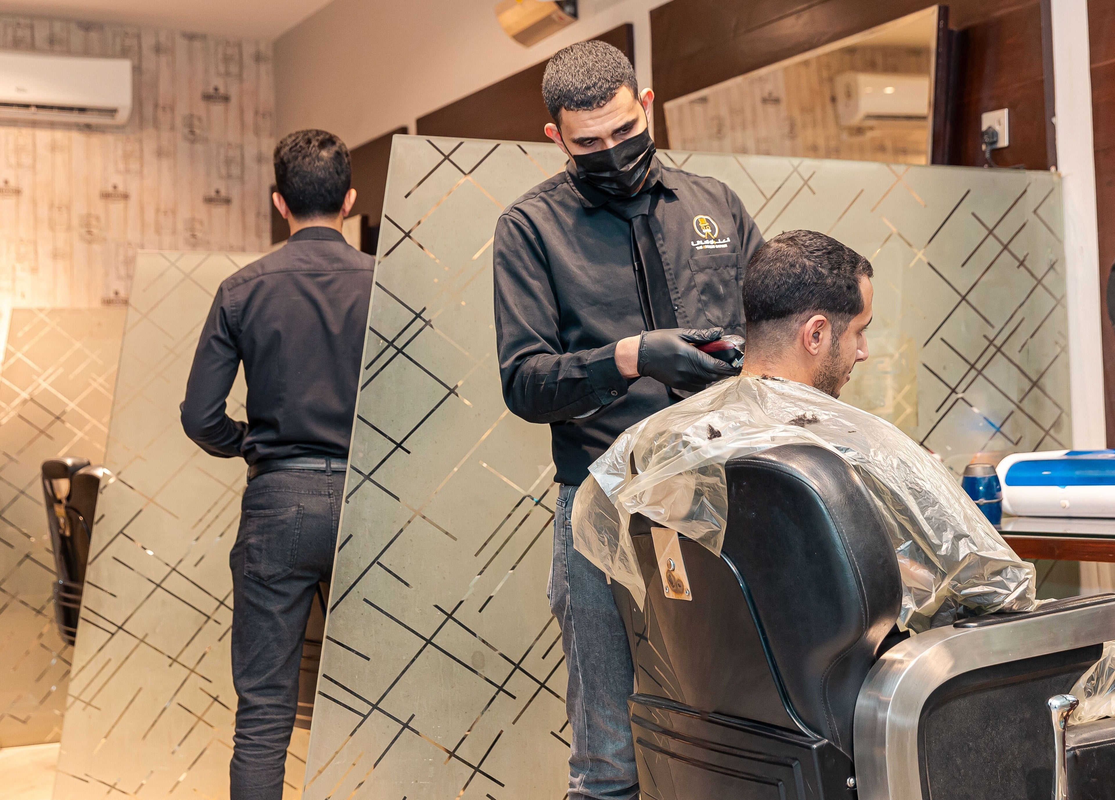 Barber styling hair at The Address Barber | صالون العنوان المونسيه in Riyadh, Riyadh Province, SA.