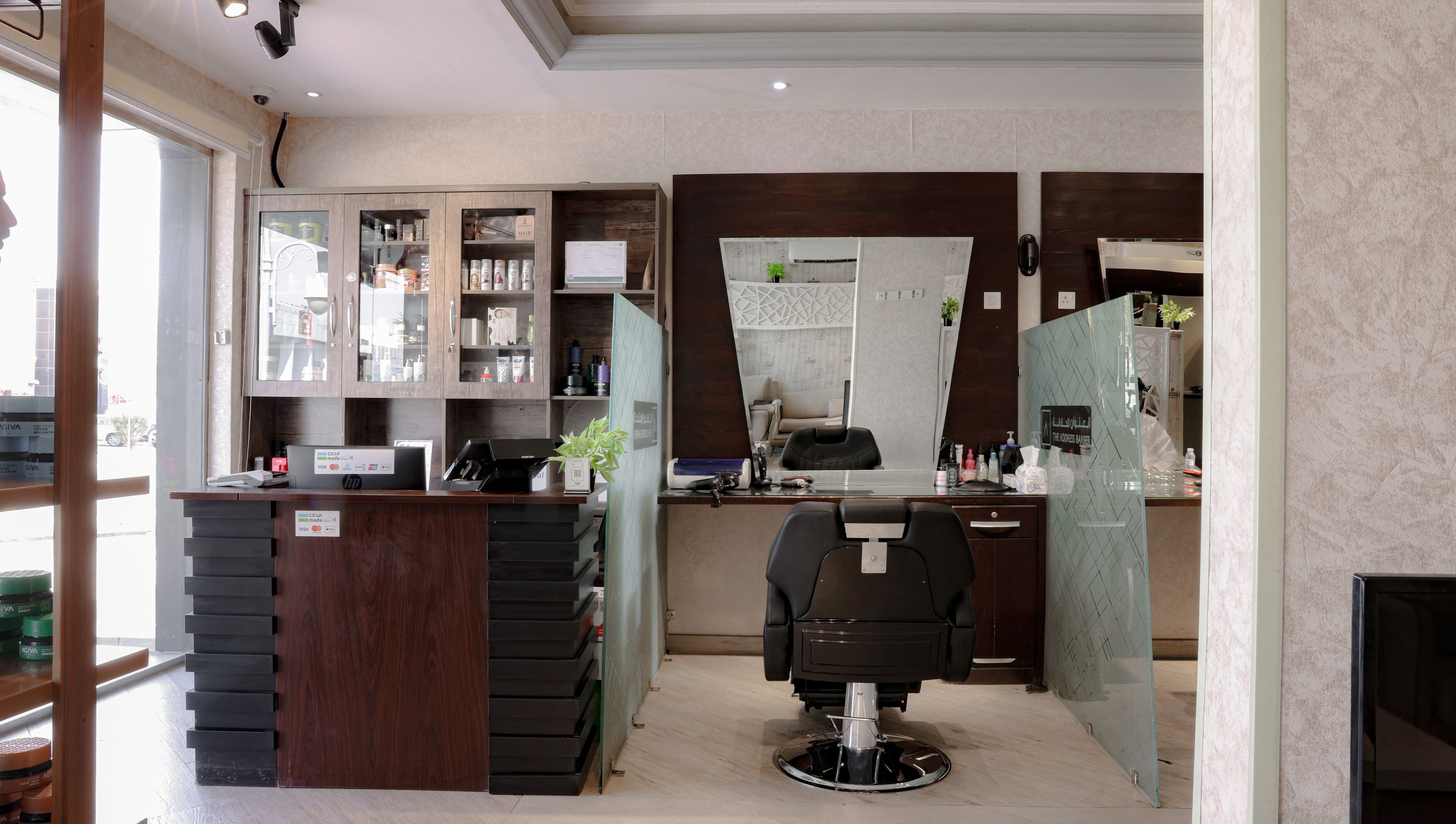 Modern interior of The Address Barber | صالون العنوان الروضة in Riyadh, SA with sleek chairs and stylish decor.