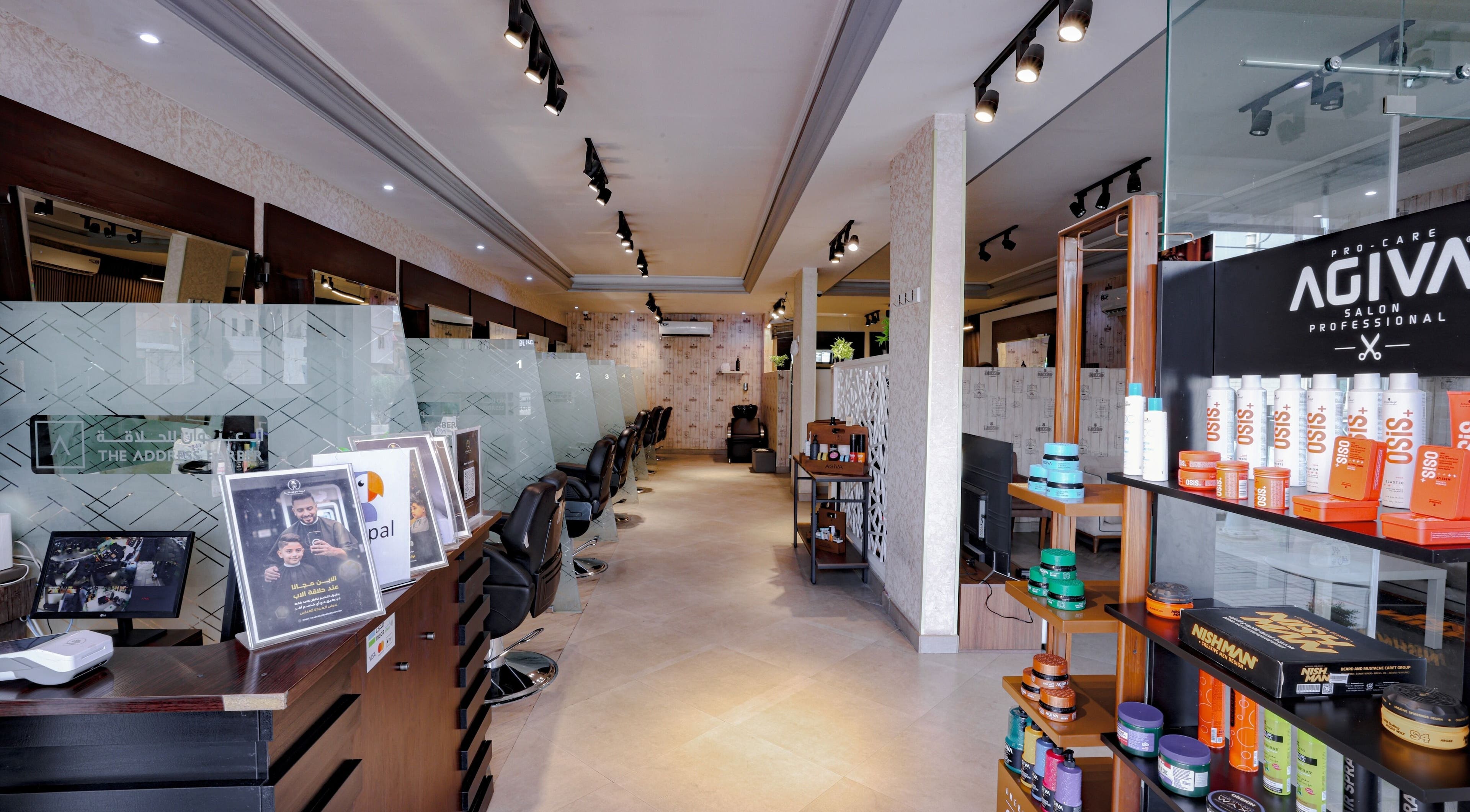Interior view of The Address Barber | صالون العنوان الروضة in Riyadh, SA showcasing stylish salon seating and products.