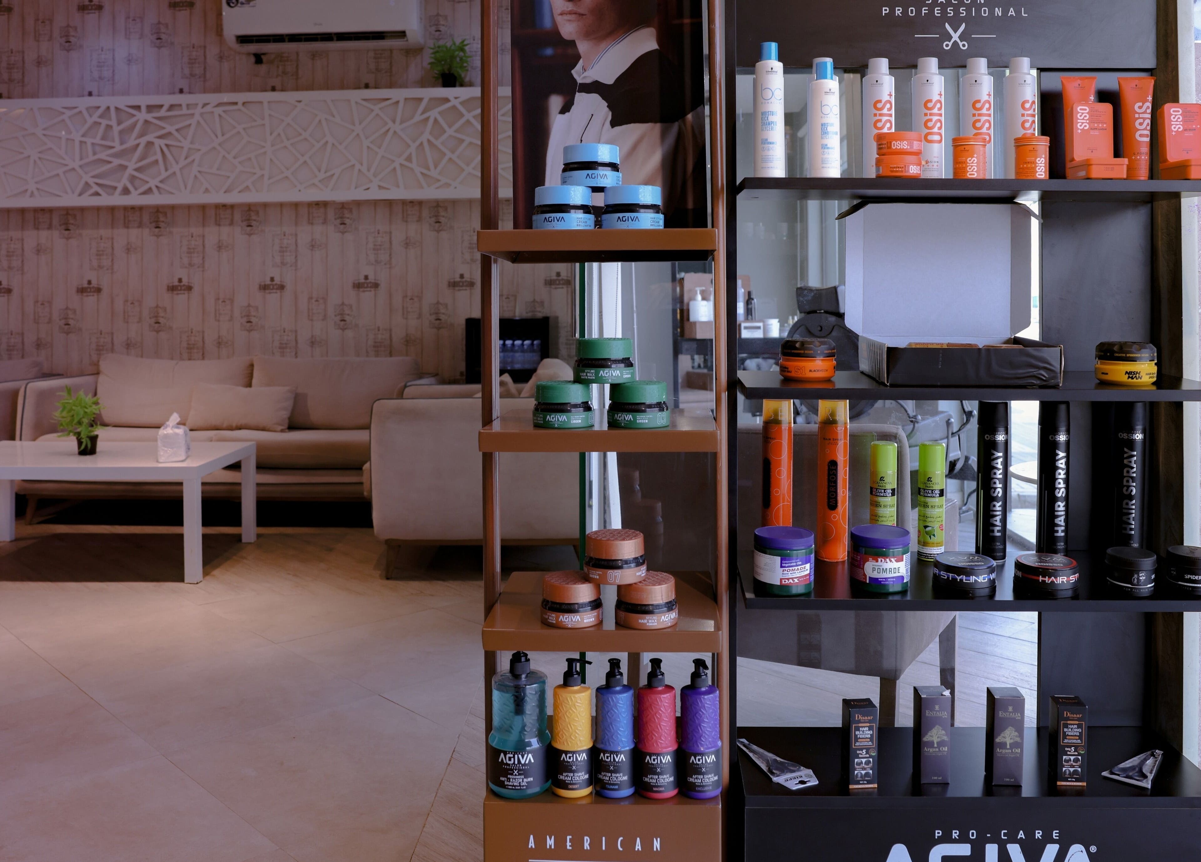 The Address Barber | صالون العنوان الروضة in Riyadh, SA offers a stylish product display in a cozy salon setting.