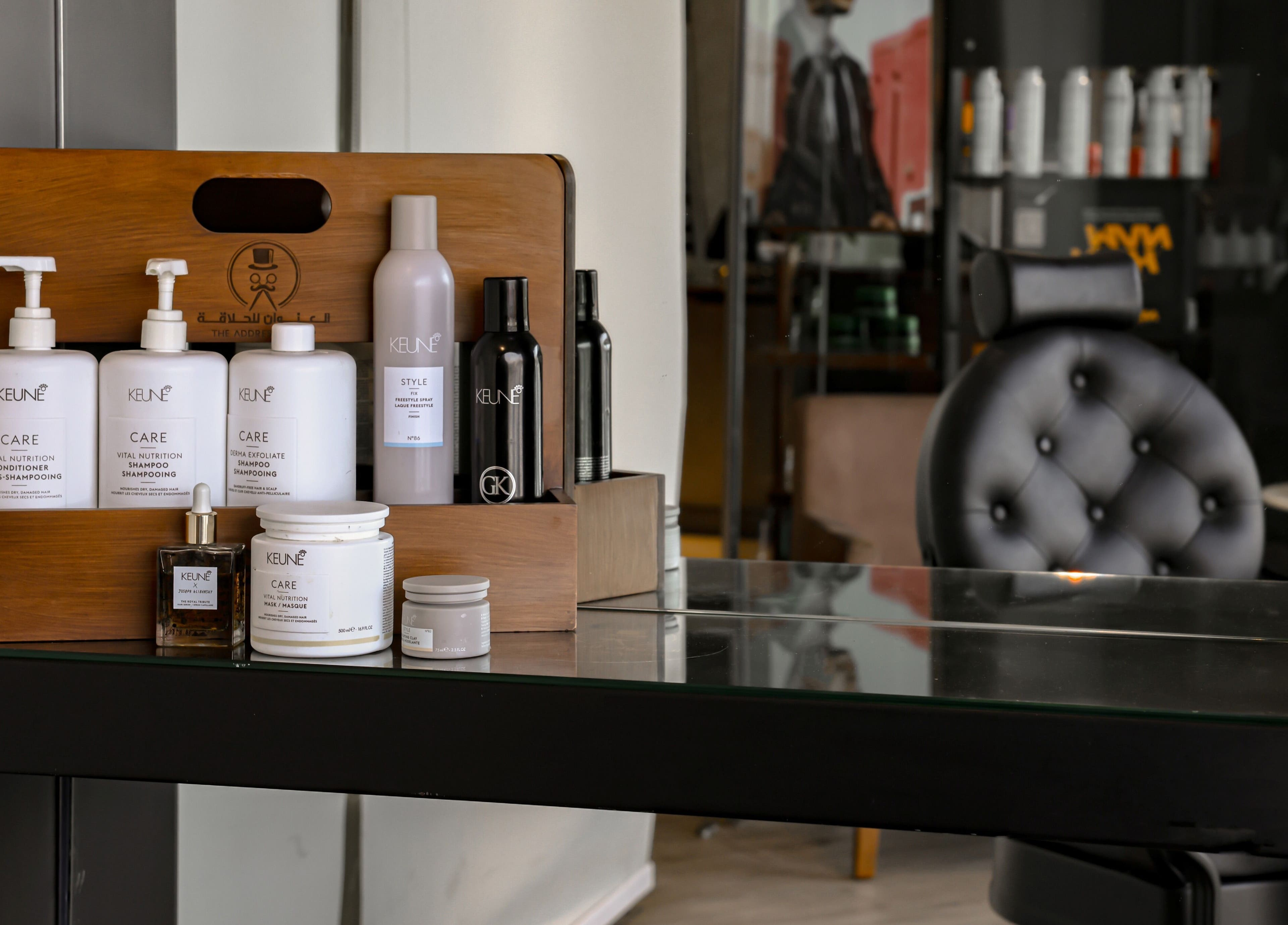 Luxury hair products at The Address Barber | صالون العنوان الروضة, Riyadh, SA, on a stylish salon shelf.
