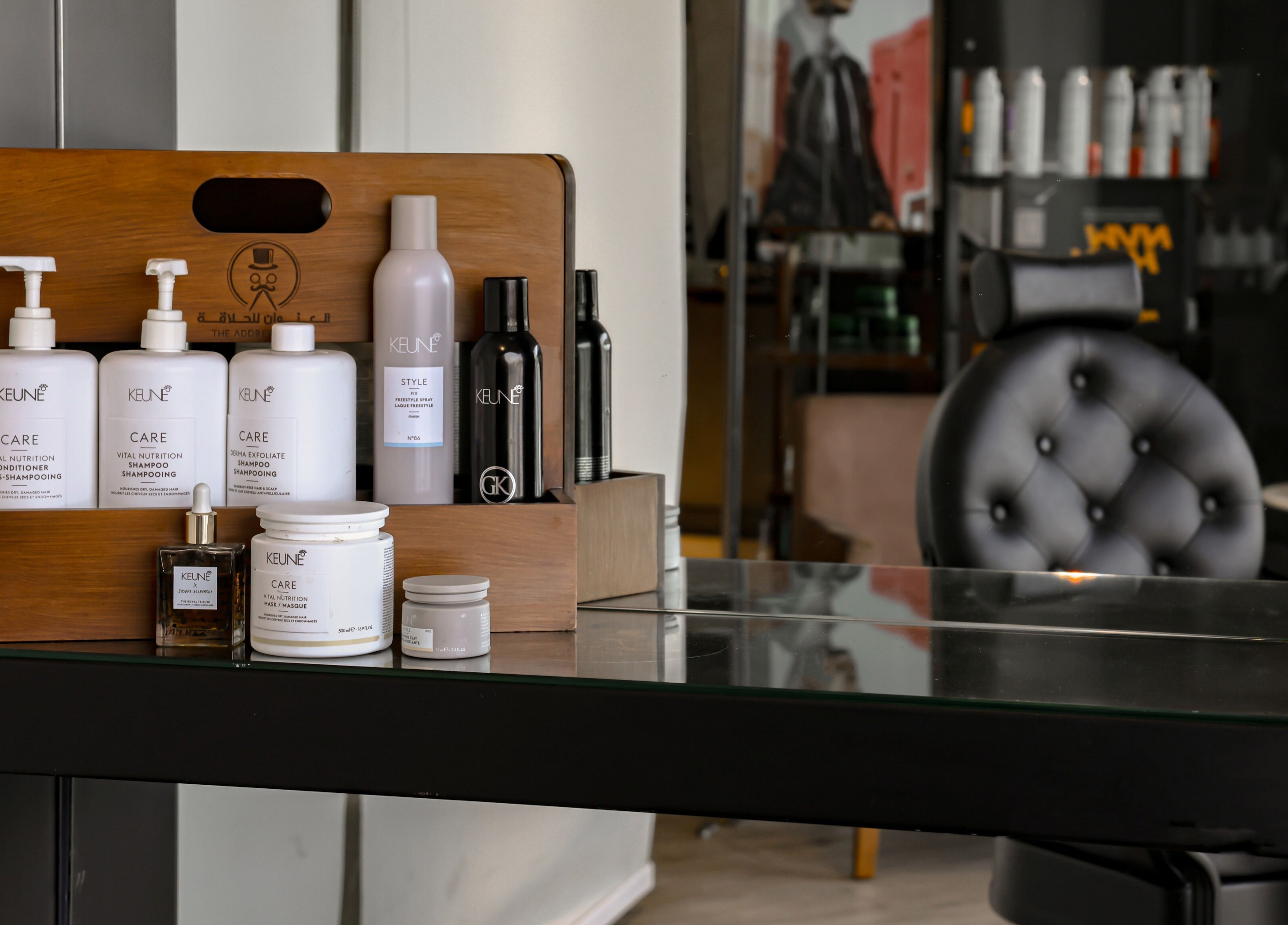 Luxury hair products at The Address Barber | صالون العنوان الروضة, Riyadh, SA, on a stylish salon shelf.