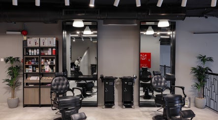 Interior of The Address Barber | صالون العنوان العارض in Riyadh, featuring modern chairs and shelving.
