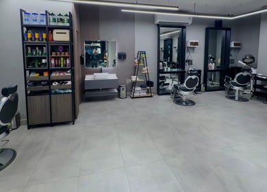 Modern interior of The Address Barber | صالون العنوان الغدير in Riyadh, featuring stylish chairs and grooming stations.