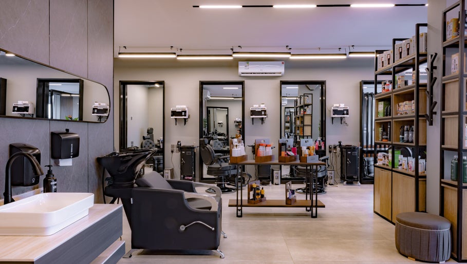 Modern interior of The Address Barber | صالون العنوان النزهة in Riyadh, Riyadh Province, SA, showcasing sleek styling stations.