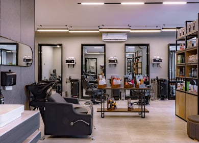 Modern interior of The Address Barber | صالون العنوان النزهة in Riyadh, Riyadh Province, SA, showcasing sleek styling stations.