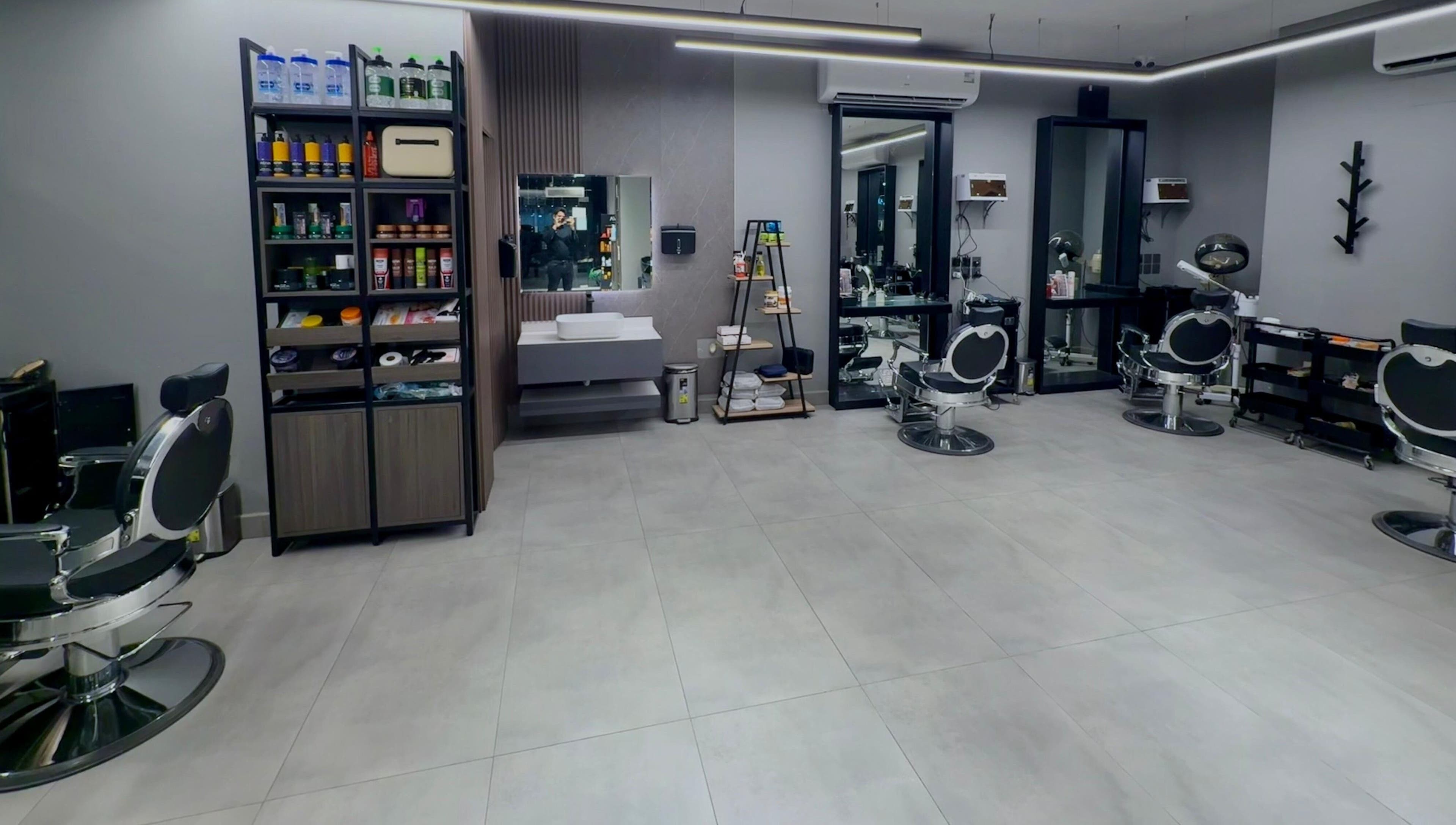 Modern interior of The Address Barber | صالون العنوان الغدير in Riyadh, Riyadh Province, SA with sleek chairs.