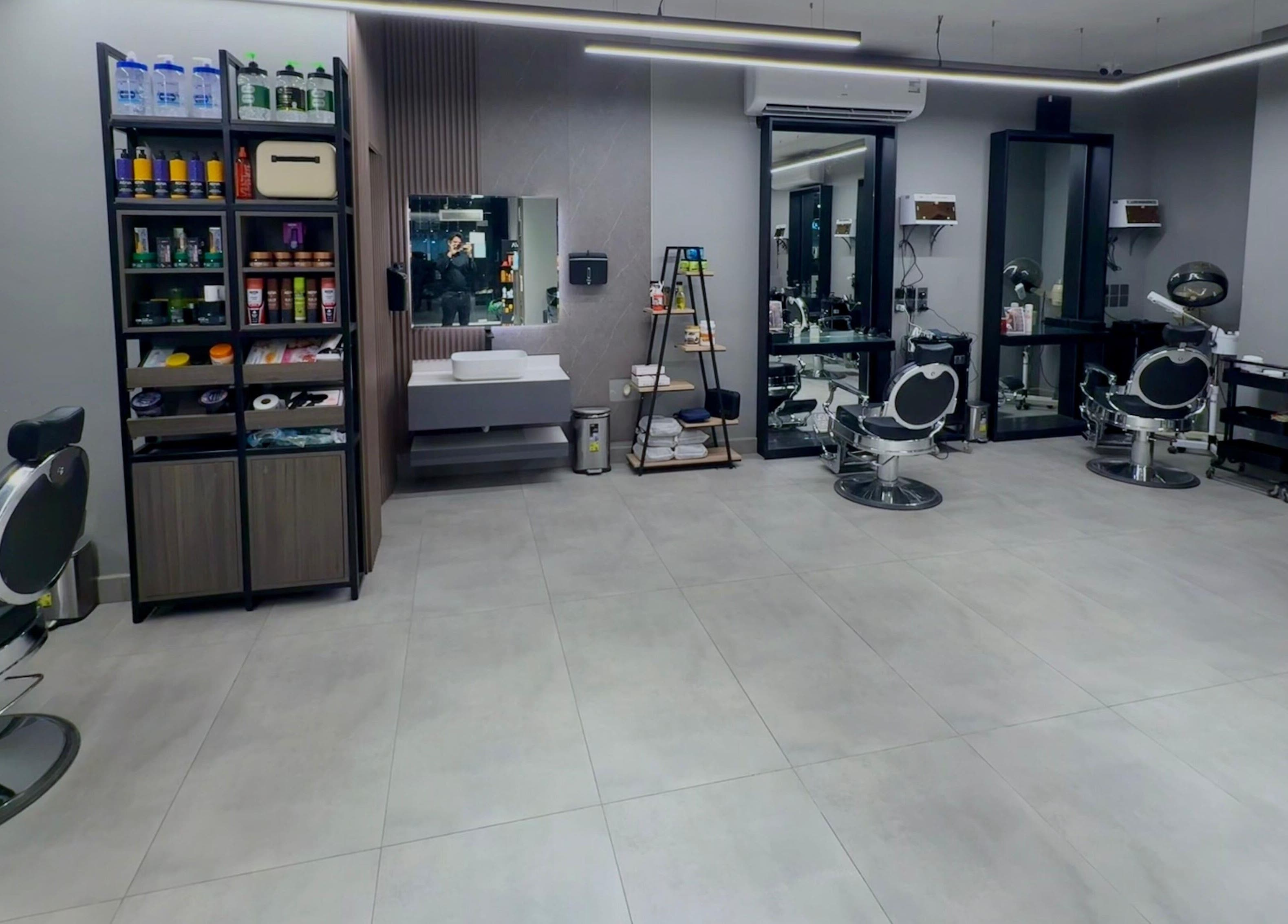 Modern interior of The Address Barber | صالون العنوان الغدير in Riyadh, Riyadh Province, SA with sleek chairs.