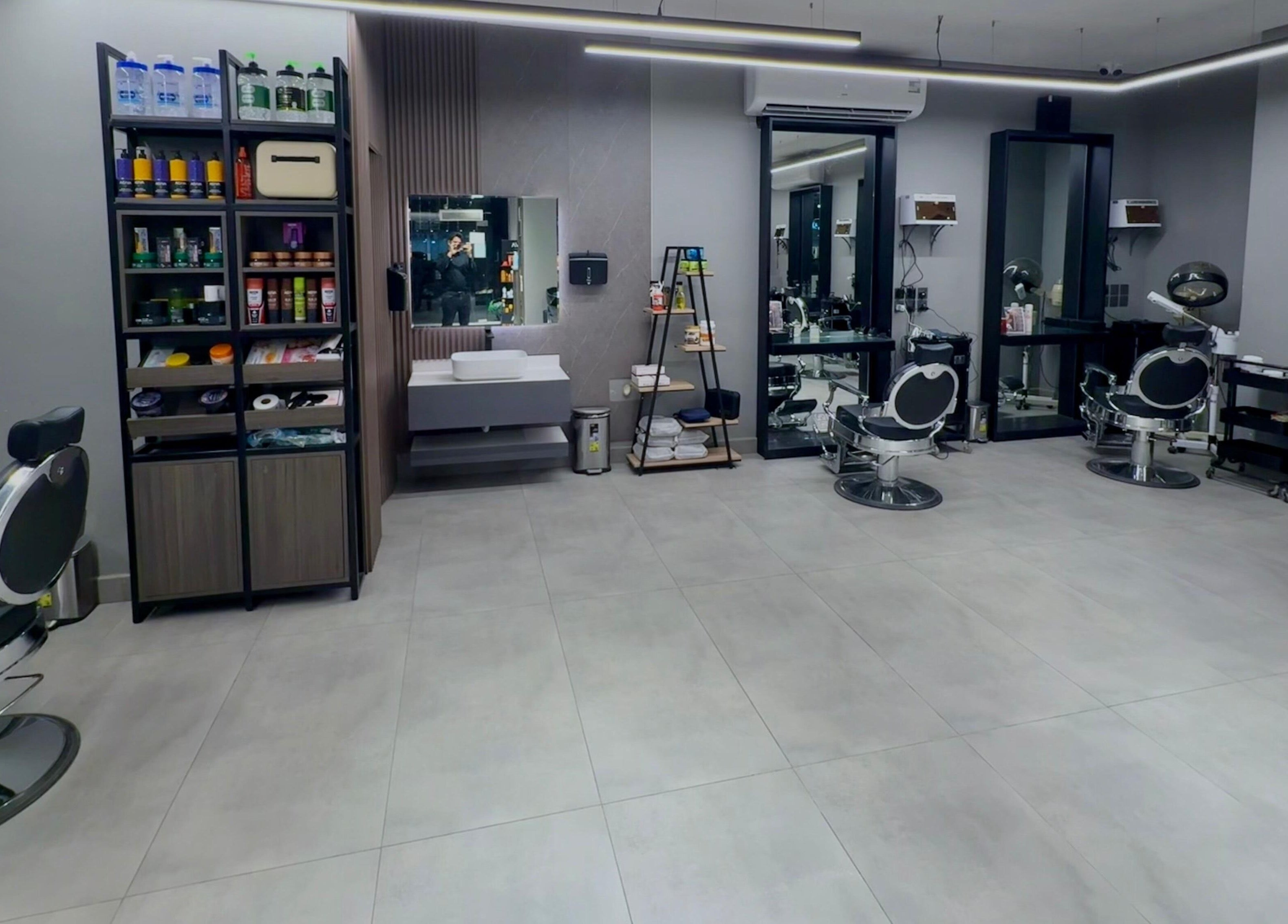 Modern interior of The Address Barber | صالون العنوان الغدير in Riyadh, Riyadh Province, SA with sleek chairs.