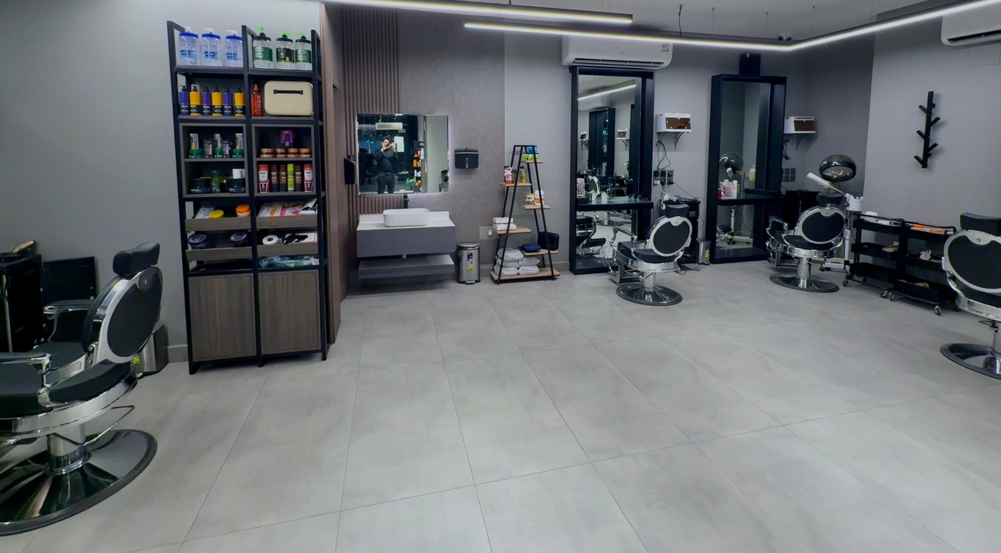 Modern interior of The Address Barber | صالون العنوان الغدير in Riyadh, Riyadh Province, SA with sleek chairs.