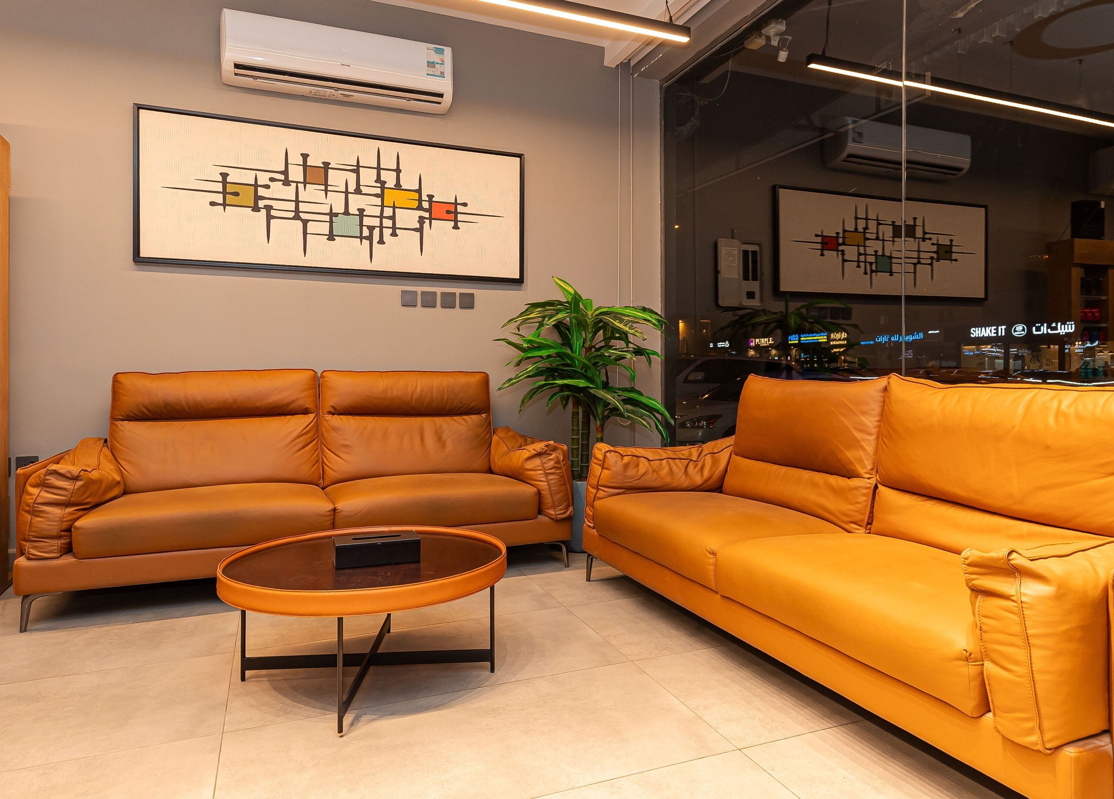 Cozy lounge area at The Address Barber | صالون العنوان الغدير in Riyadh, Riyadh Province, SA with leather sofas.
