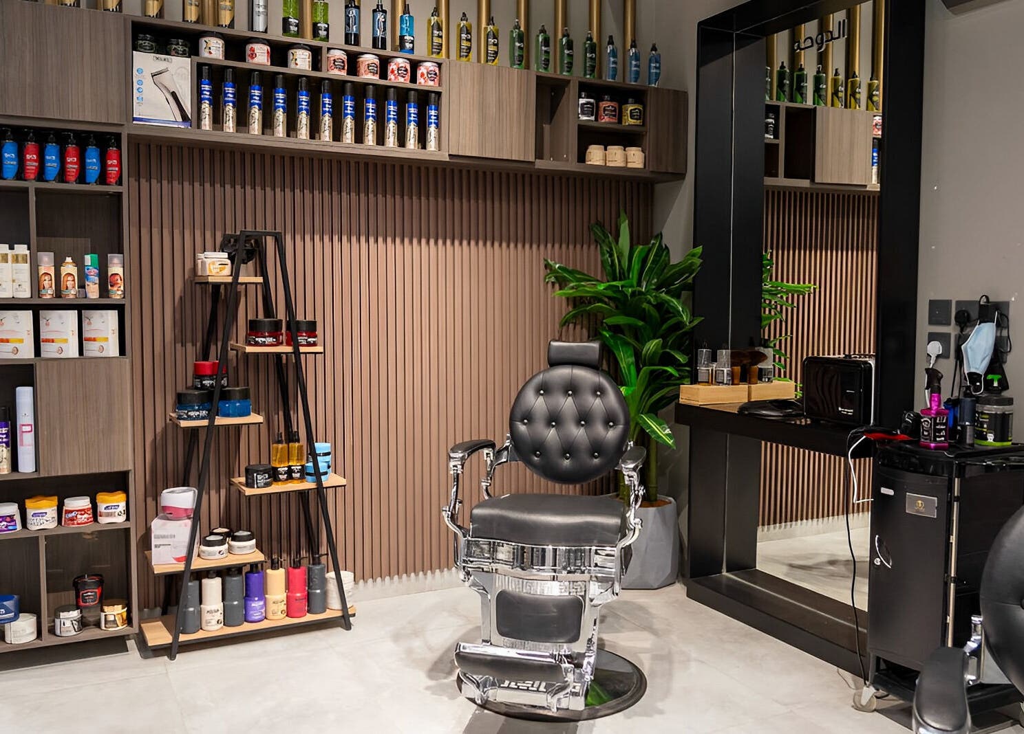 Sleek interior of The Address Barber | صالون العنوان الملقا in Riyadh, featuring modern barber chair.