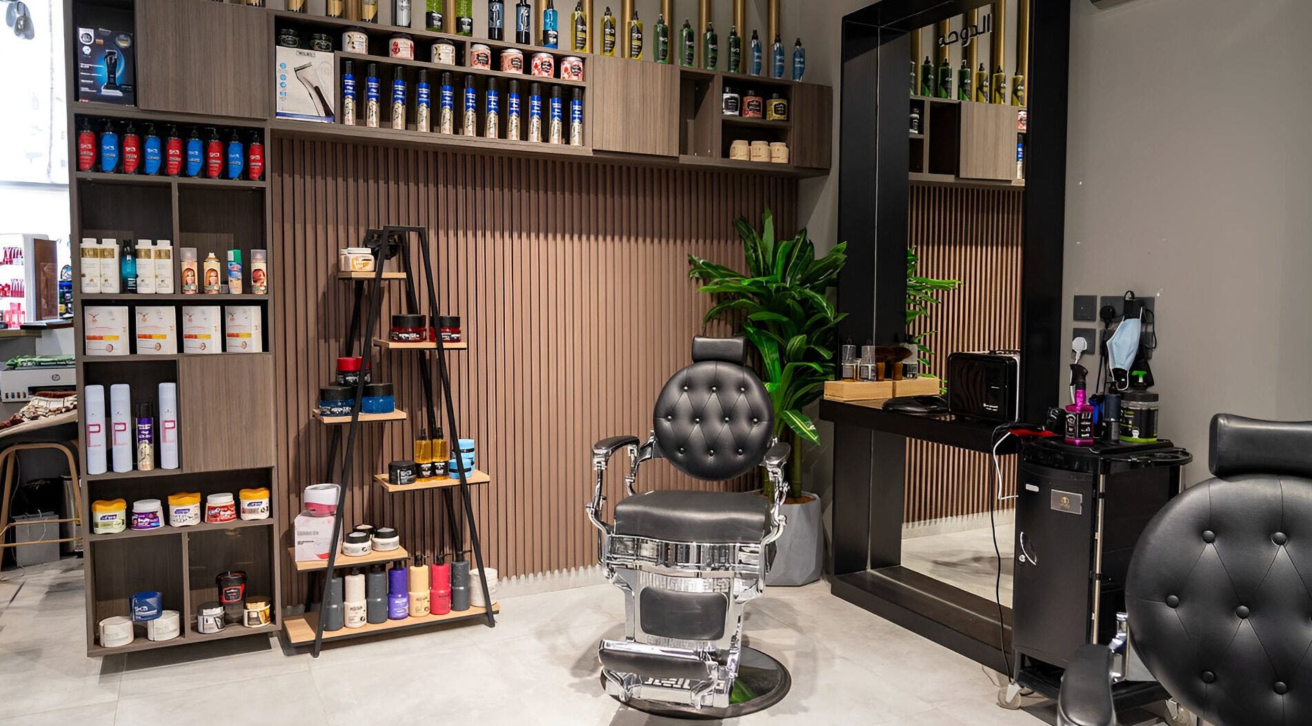 Sleek interior of The Address Barber | صالون العنوان الملقا in Riyadh, featuring modern barber chair.