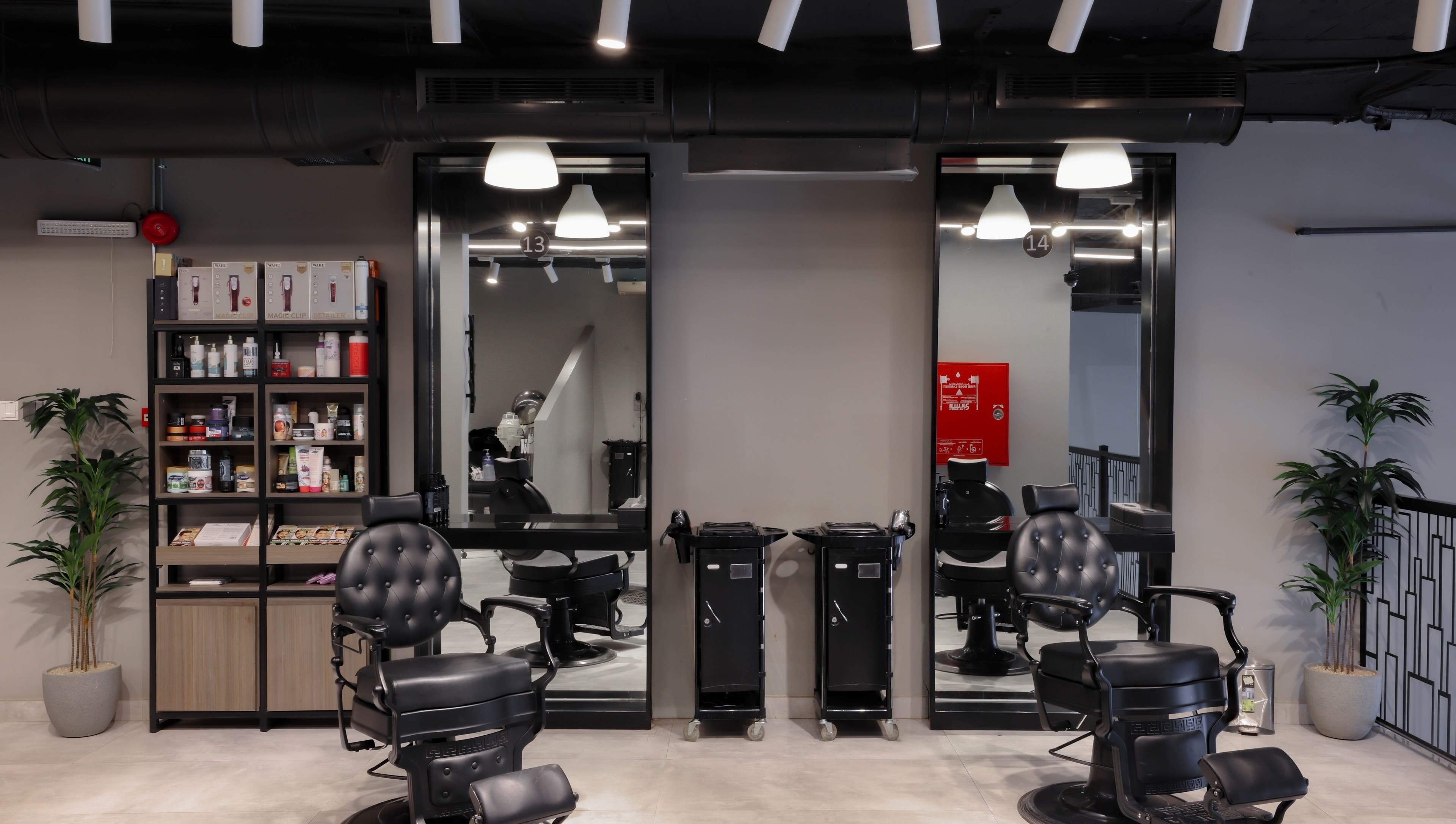Interior of The Address Barber | صالون العنوان العارض, Riyadh showcasing modern chairs and products.