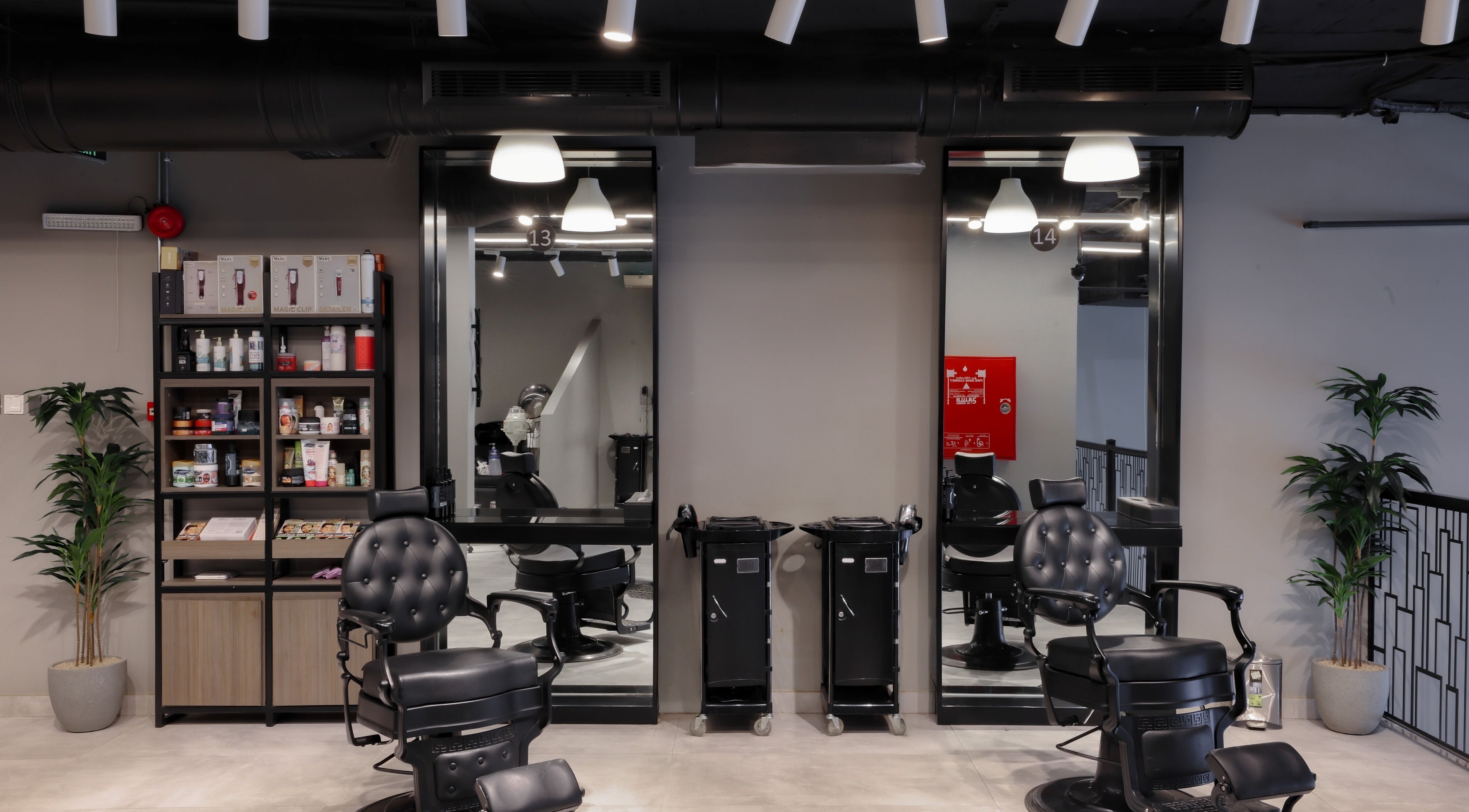 Interior of The Address Barber | صالون العنوان العارض, Riyadh showcasing modern chairs and products.