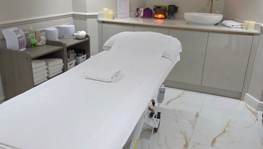 Treatment room at CDT Beauty in Morecambe, England, GB with a plush massage table and soothing decor.