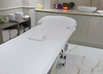 Treatment room at CDT Beauty in Morecambe, England, GB with a plush massage table and soothing decor.