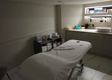 Elegant treatment room at CDT Beauty, Morecambe, England, GB featuring a massage table and ambient lighting.