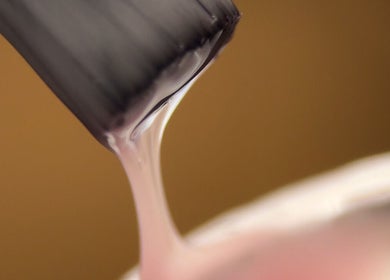 Close-up of nail polish brush at Ocean Bloom - Helston, Helston, England, GB, emphasizing precision beauty.