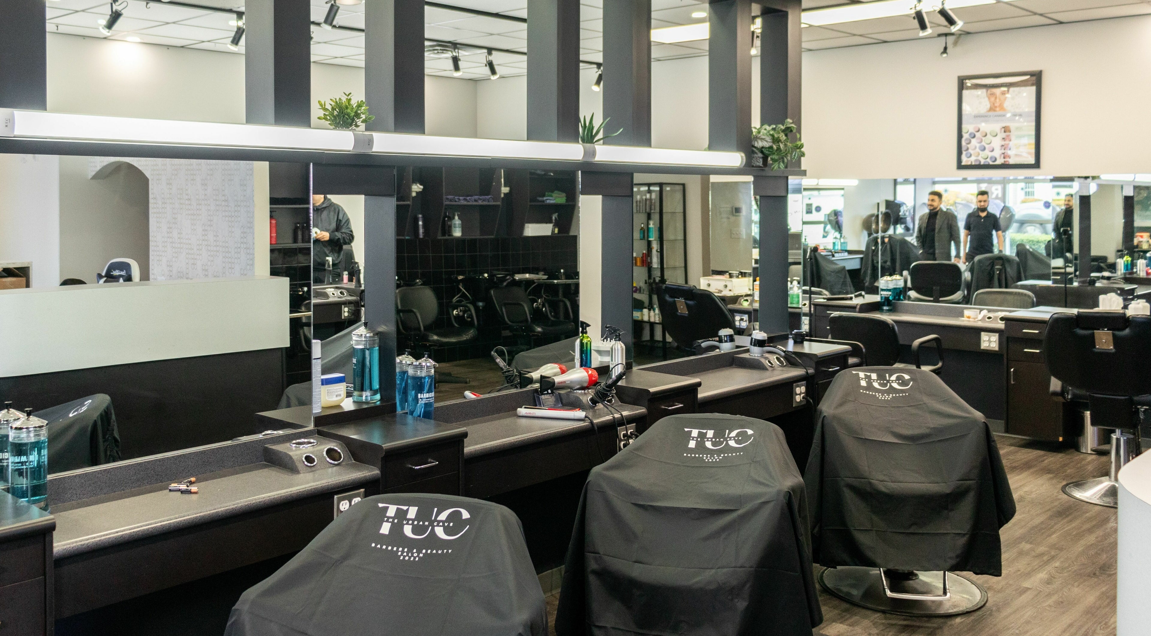 Spacious interior of The Urban Cave salon in Surrey, BC featuring modern styling stations and sleek decor.